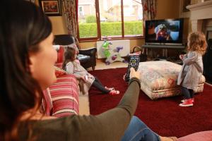 Family watching TV using electricity